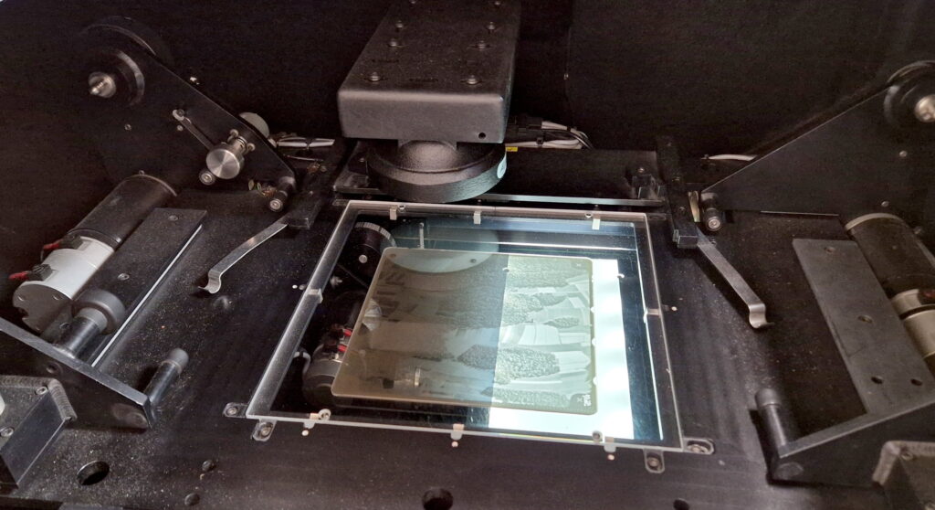 The illustration shows archival aerial photos taken on glass plates using a photogrammetric scanner