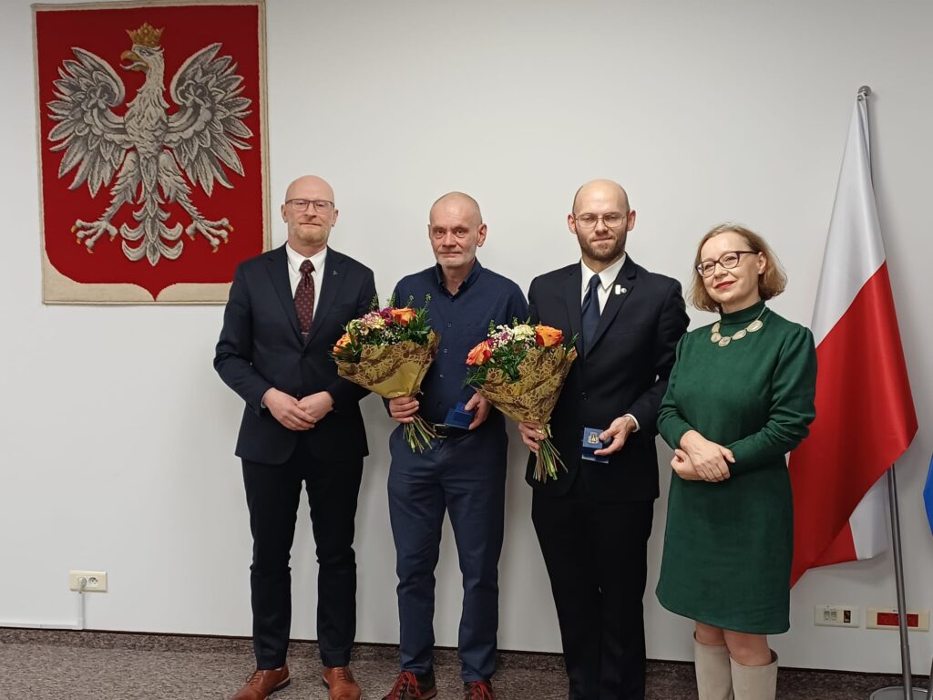 Główny Geodeta Kraju Andrzej Żylis i Naczelnik Wydziału Orzecznictwa Administracyjnego i Konserwatorskiego MKiDN Katarzyna Dutkowska z nagrodzonymi Mariuszem Meusem i Patrykiem Charydczakiem